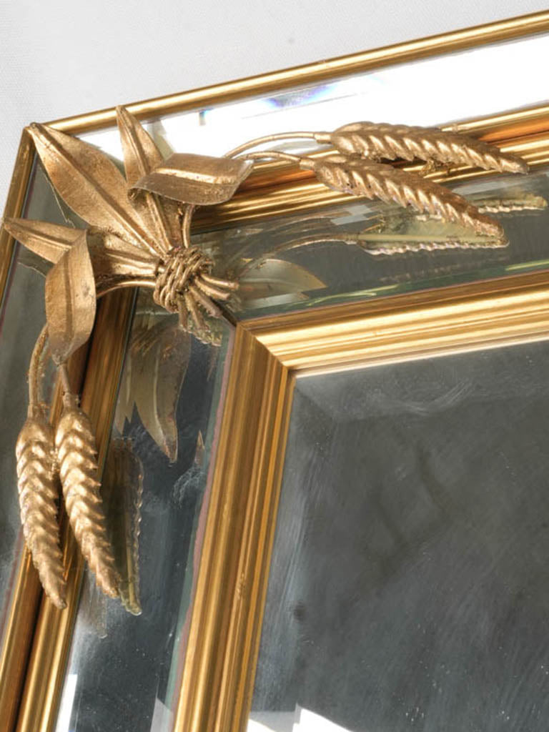 Ornate mirror with aged patina.