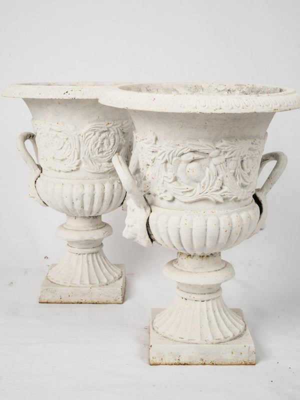 Antique white cast iron urns