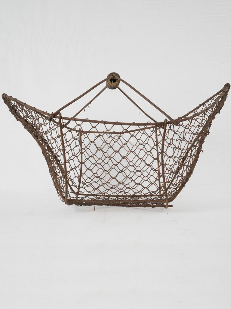 Rustic, open-weave antique wire basket