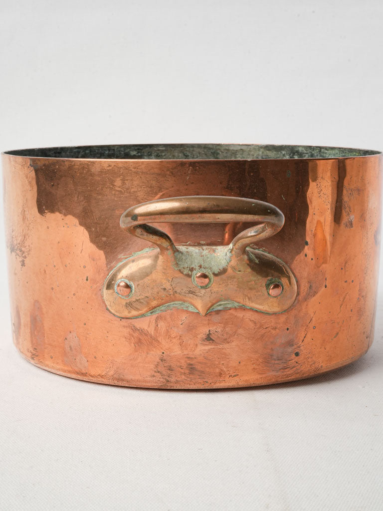 Warm-toned brass-handled marmite