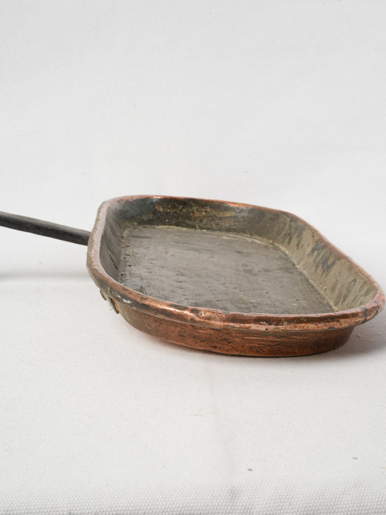 Historic artisanal iron-handled pan  