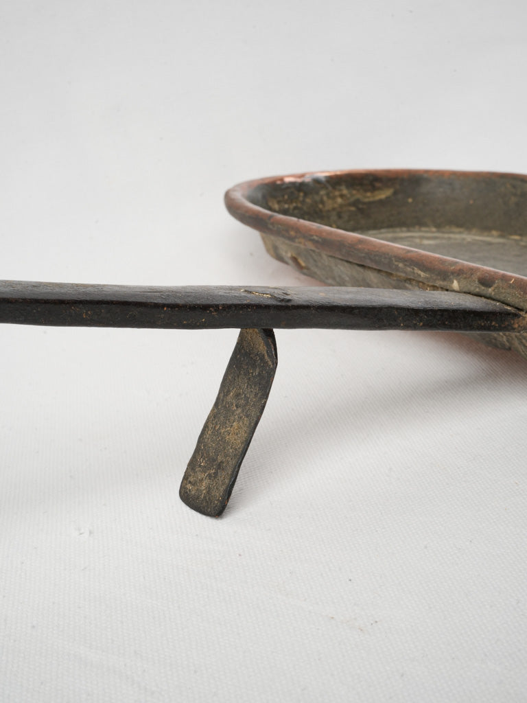 Aged warm-toned copper kitchen accessory  