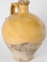 Antique yellow-glazed French plongeon pitcher