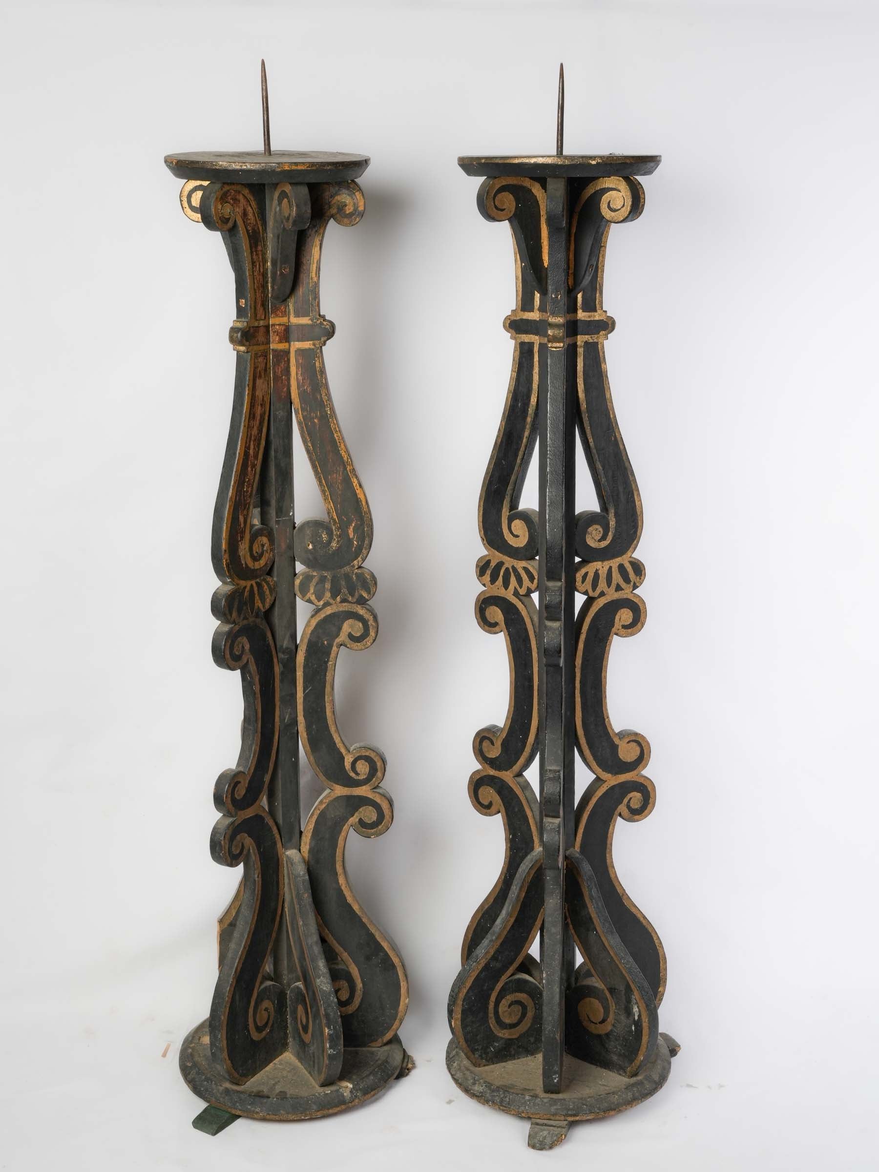 Sculptural scrolling designed candle stands  