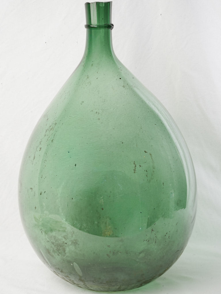 Antique handcrafted green glass demijohn