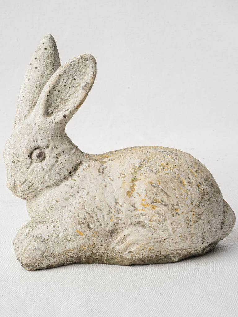 Graceful moss-accented rabbit sculpture  