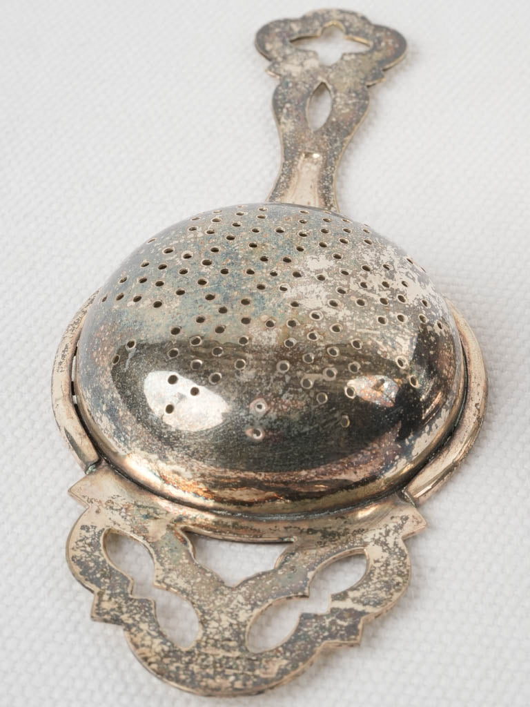 Delicate silver-plated tea strainer