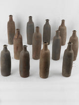 Collection of 12 terracotta long bottles from Normandy 11¾"