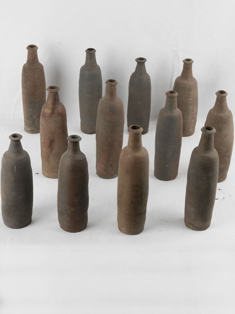 Collection of 12 terracotta long bottles from Normandy 11¾"