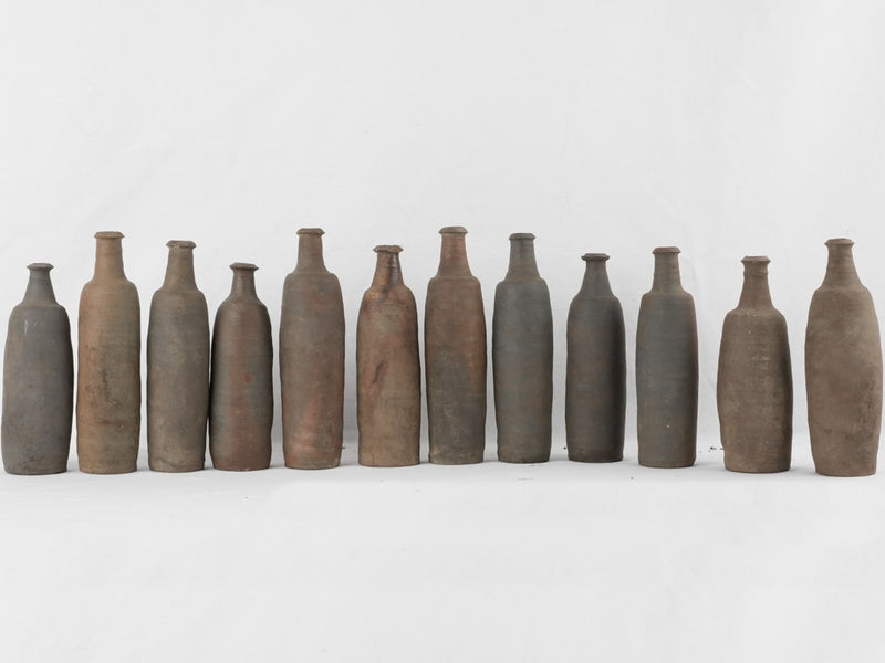 Collection of 12 terracotta long bottles from Normandy 11¾"