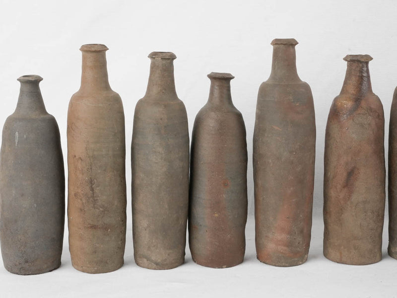 Collection of 12 terracotta long bottles from Normandy 11¾"