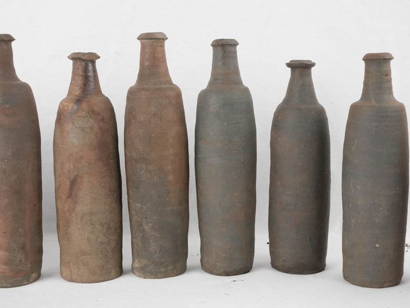 Collection of 12 terracotta long bottles from Normandy 11¾"