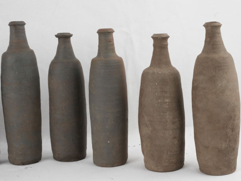 Collection of 12 terracotta long bottles from Normandy 11¾"