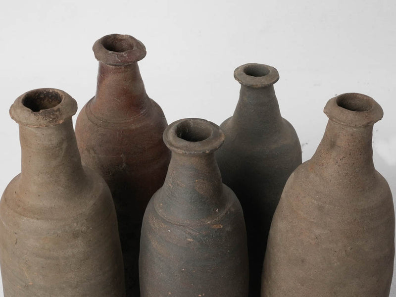 Collection of 12 terracotta long bottles from Normandy 11¾"