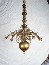 Aged brass ornate scrollwork chandelier