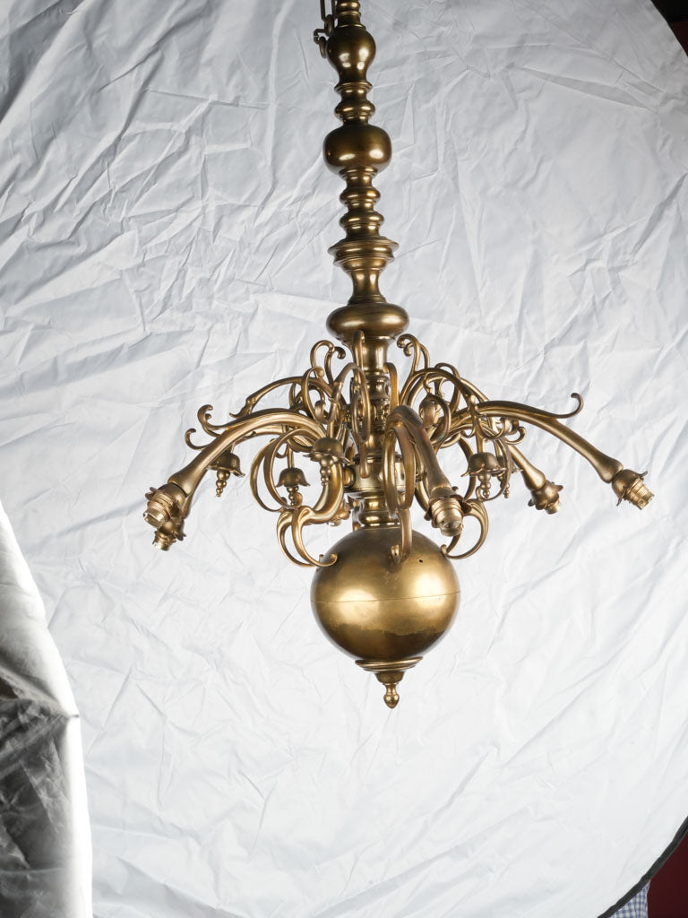 Elegant weighty brass chandelier detailing