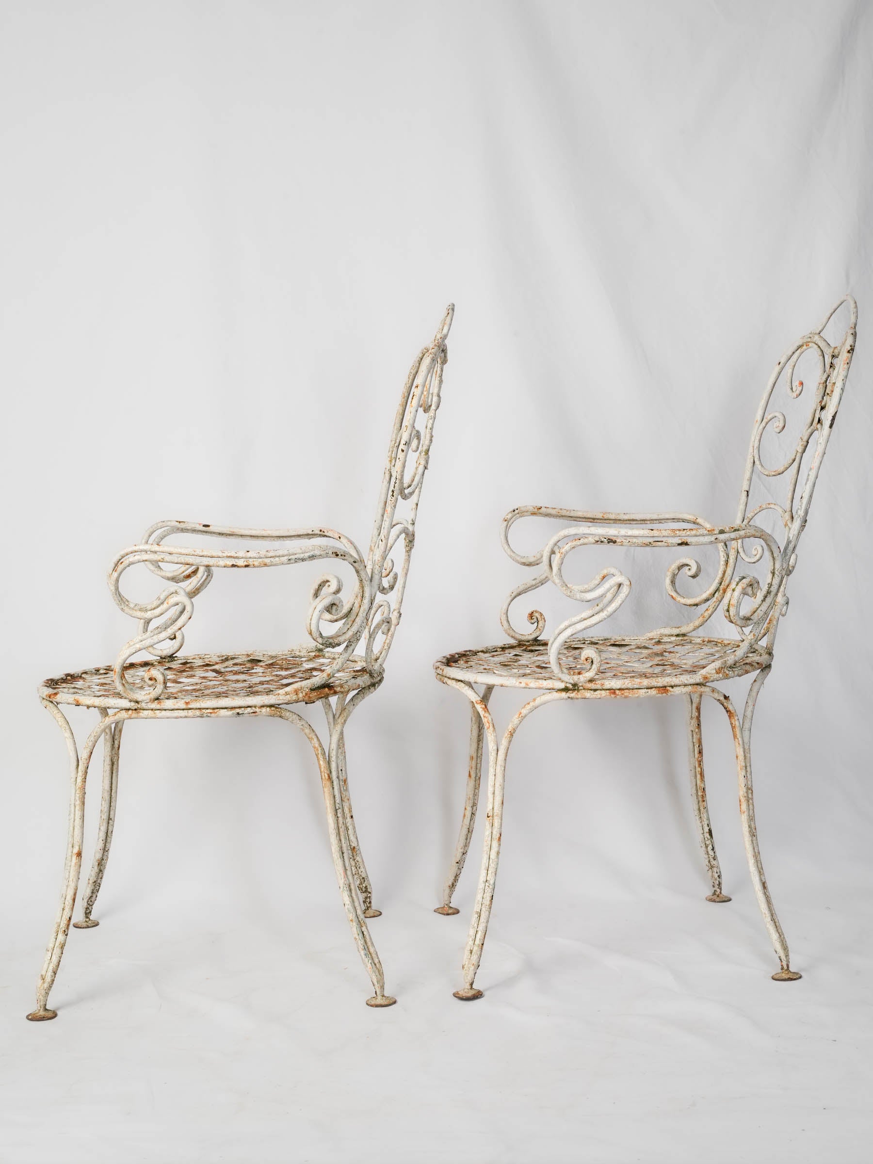 Ornamental scrolling wrought iron chairs  
