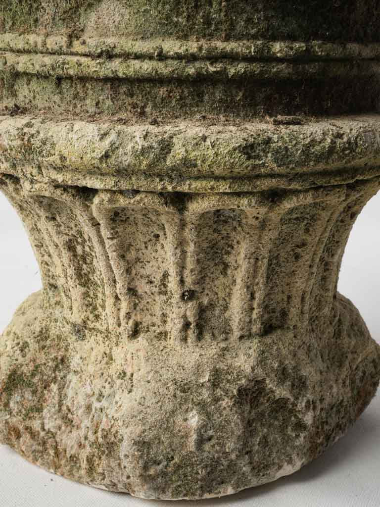 Historic moss-covered limestone planter
