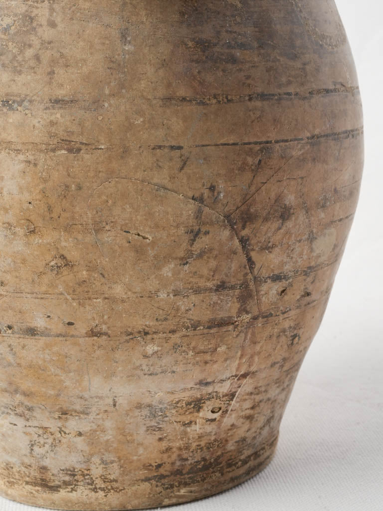 Buff-toned antique pottery jug  