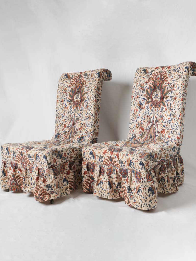Pair of upholstered chairs w/ ruffle skirts & front wheels