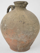 Patina-detailed European half-glazed clay jug
