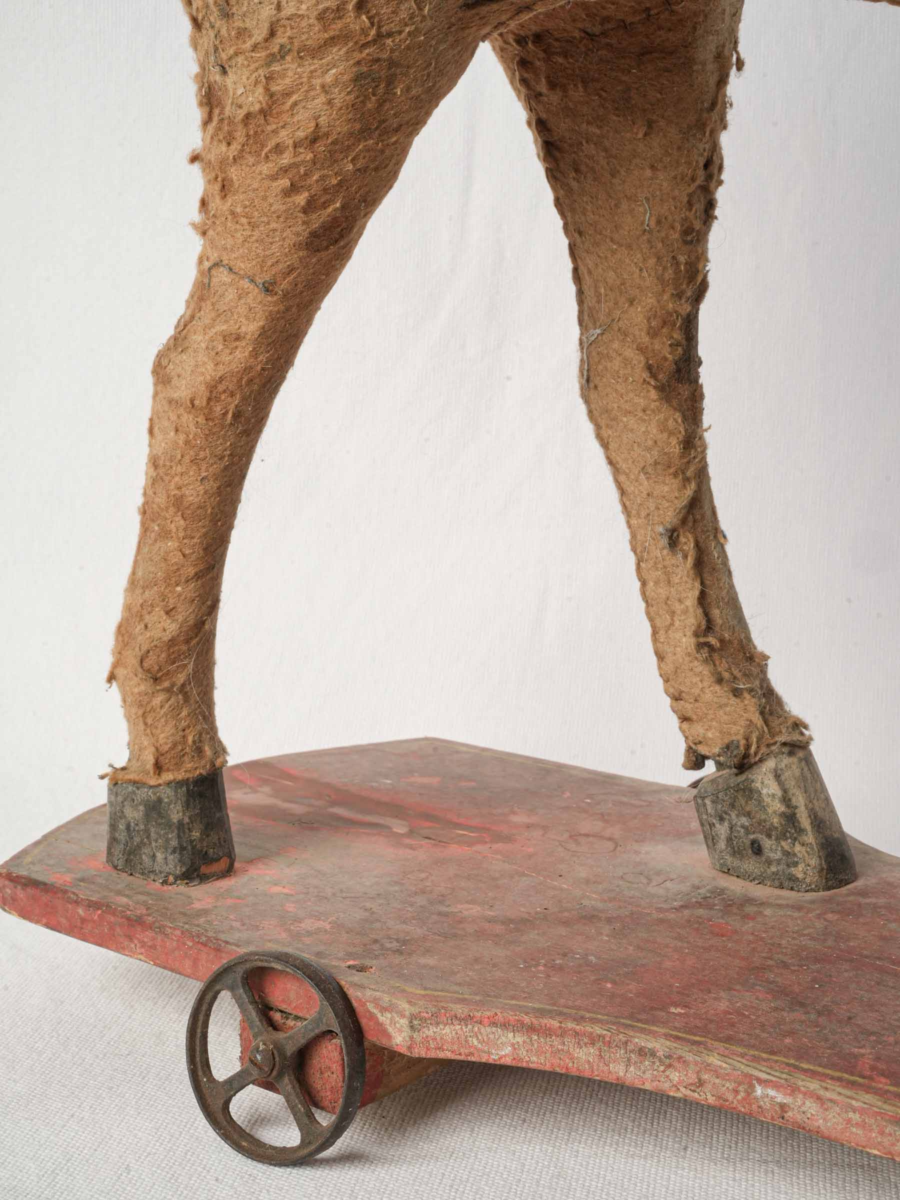 Shaped red-painted platform horse