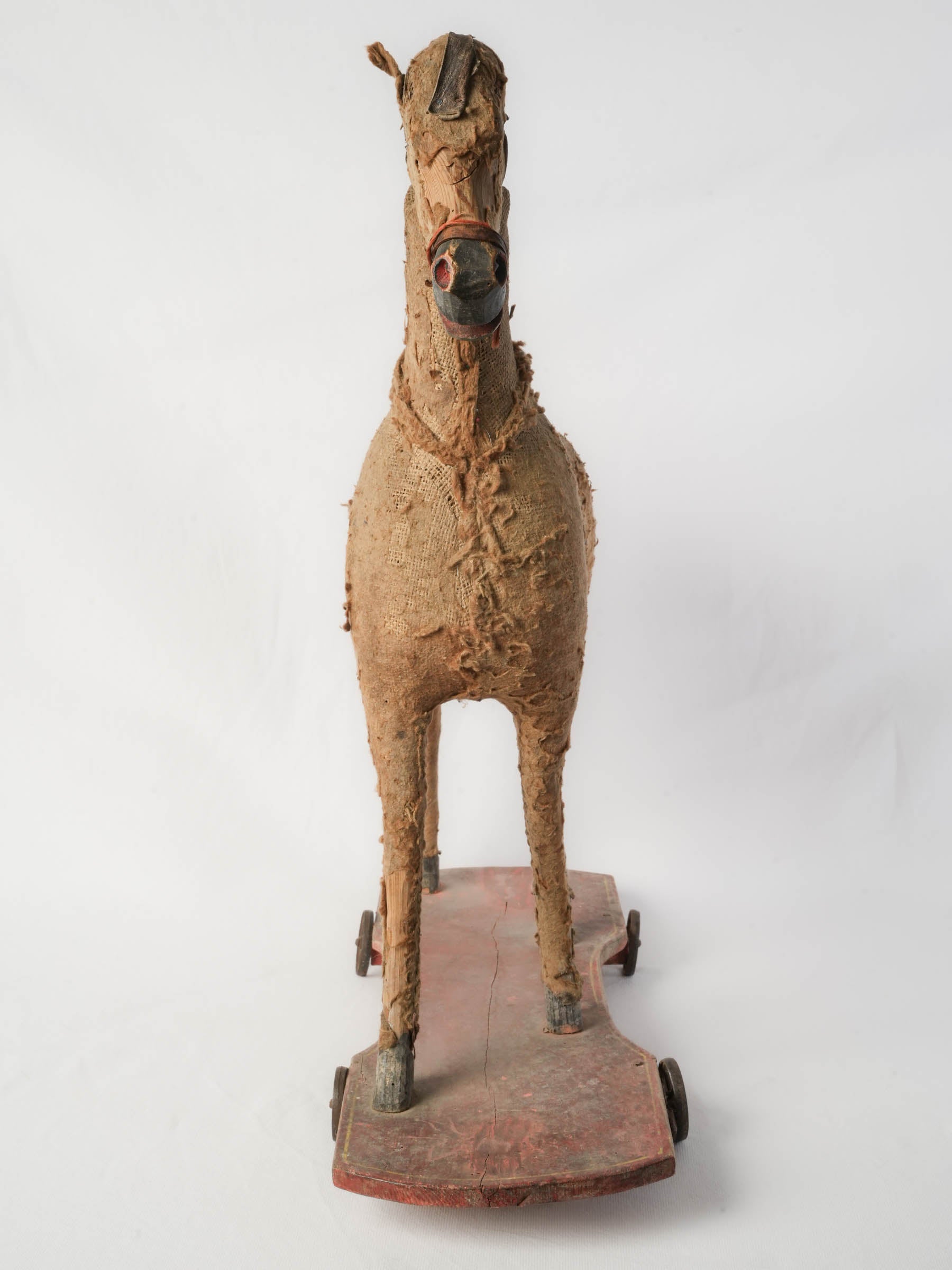 Vintage iron-wheeled horse figurine