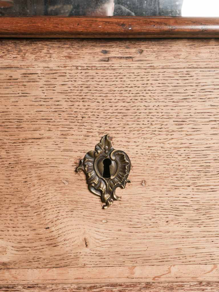 Ornate bronze-accented storage furniture