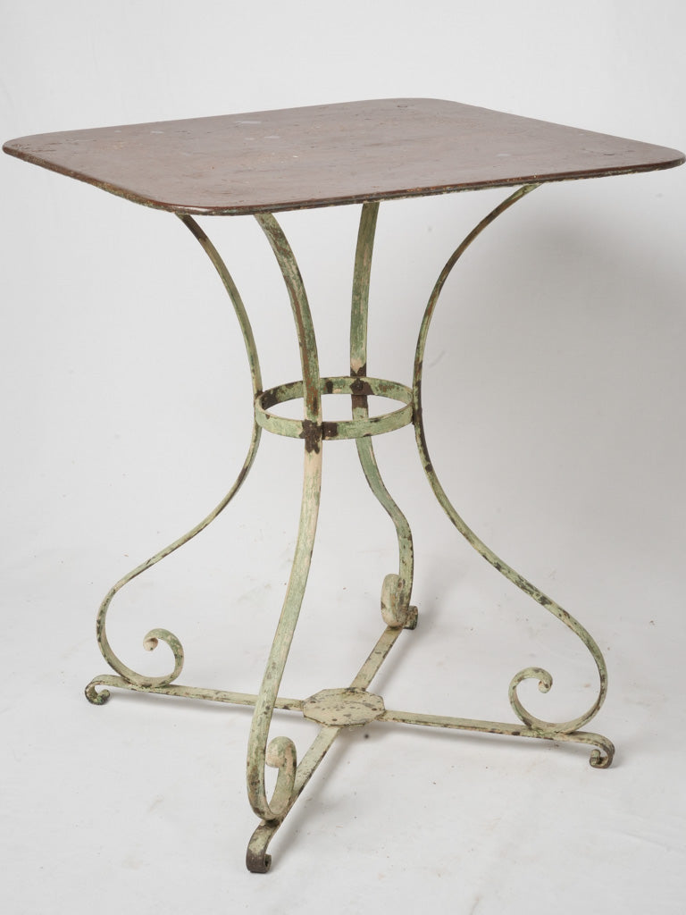 Elegant scrolled base iron garden table