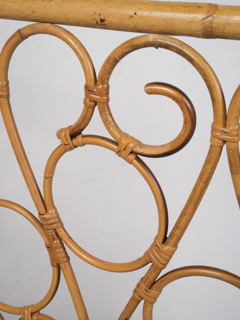 Intricate scrollwork rattan cradle  