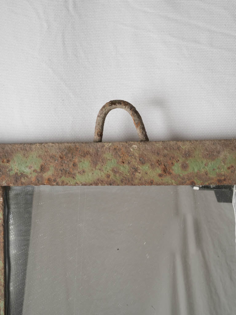 Salvaged green-speckled iron mirror decor