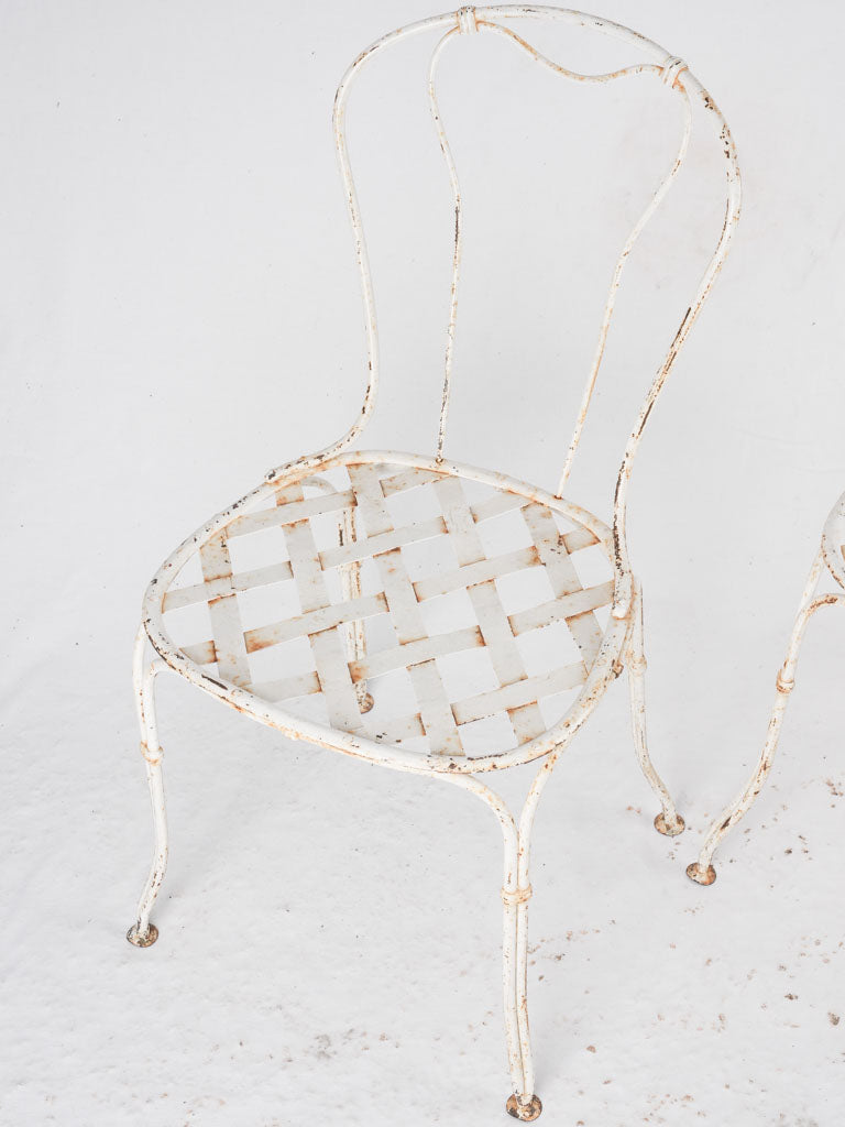 Pair of white lattice garden chairs