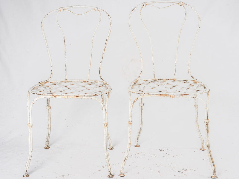 Pair of white lattice garden chairs