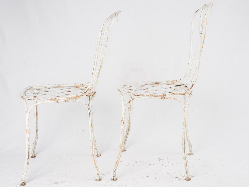 Pair of white lattice garden chairs
