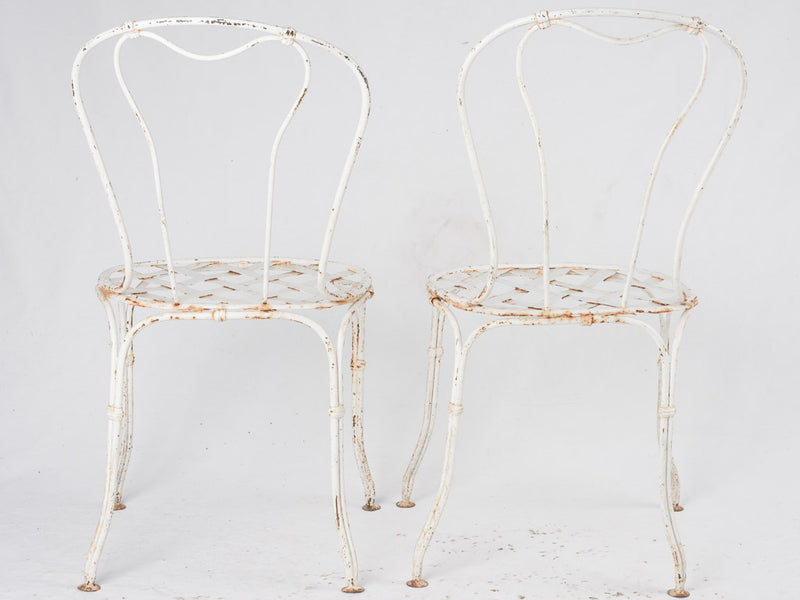 Pair of white lattice garden chairs