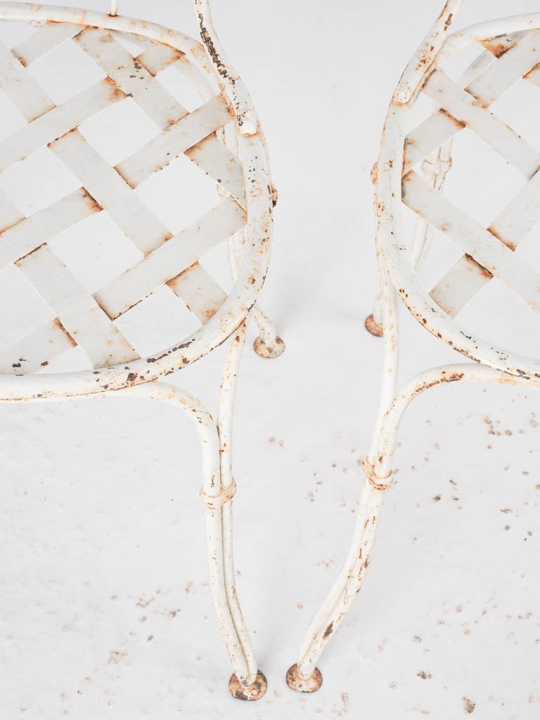 Pair of white lattice garden chairs