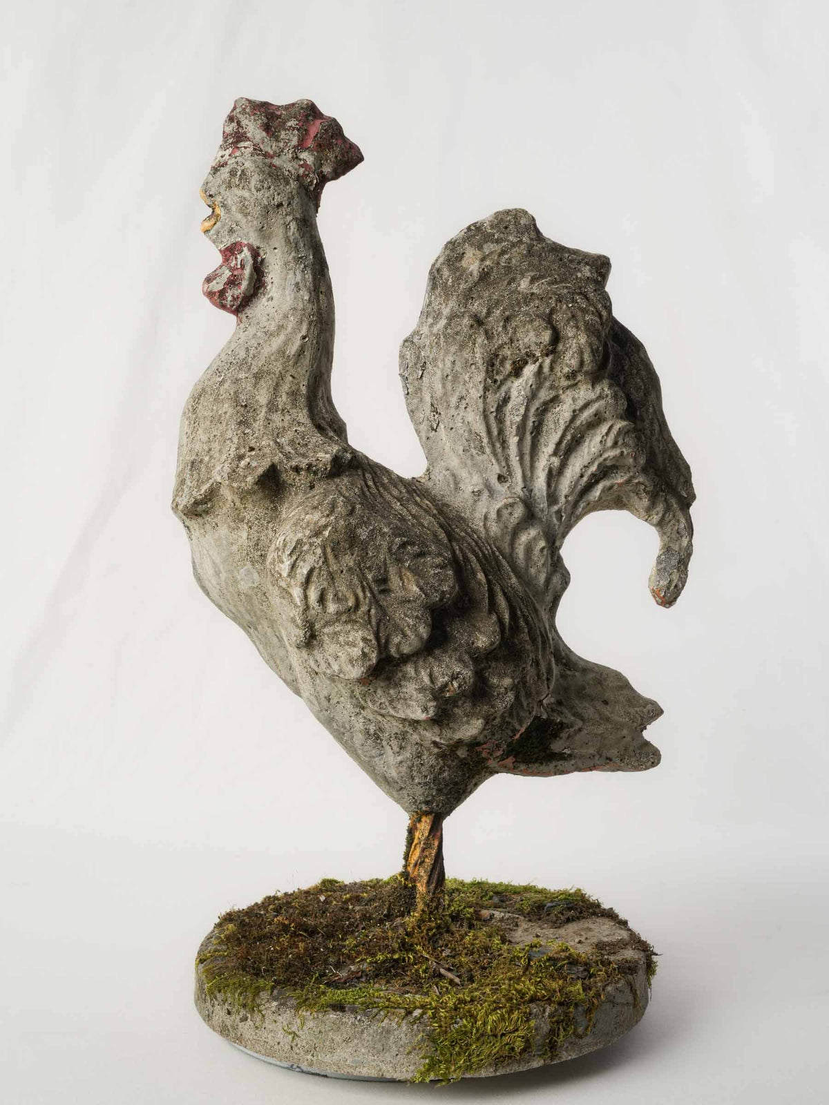 Aged mossy garden concrete rooster