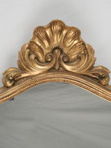 Antique stylized shell-crowned bedroom mirror