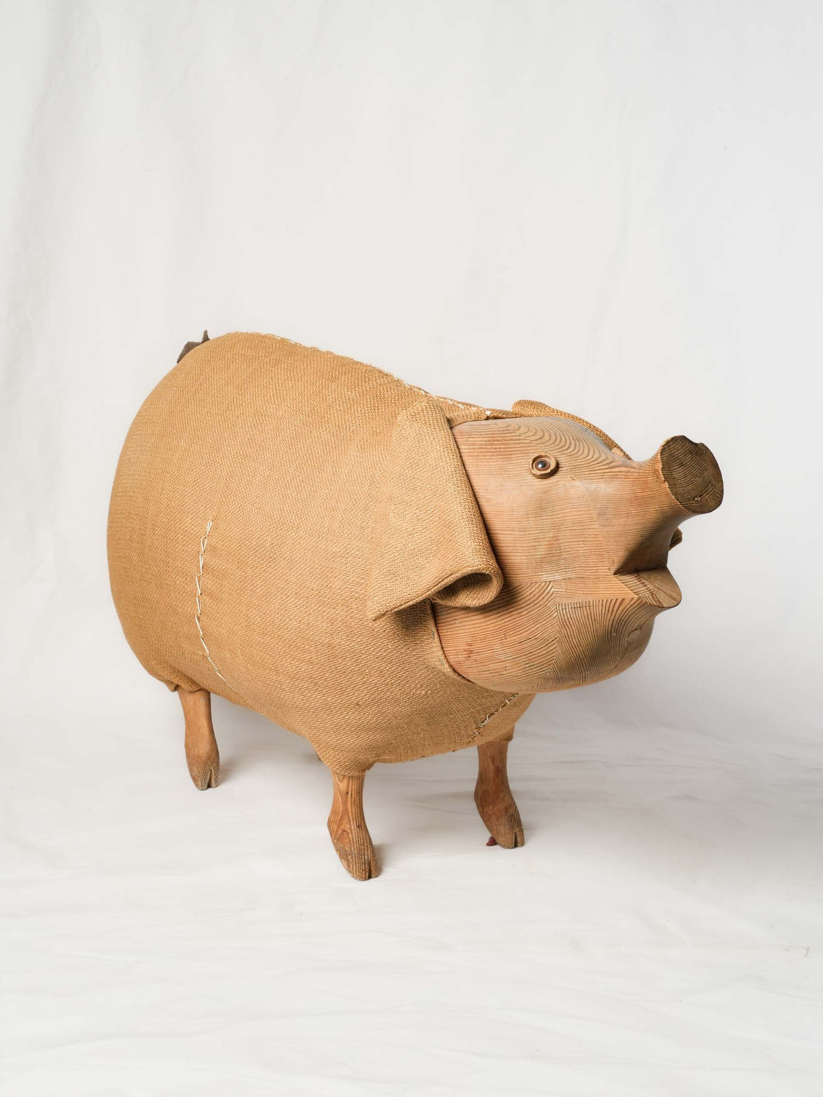 Expressive pine-carved pig statue  