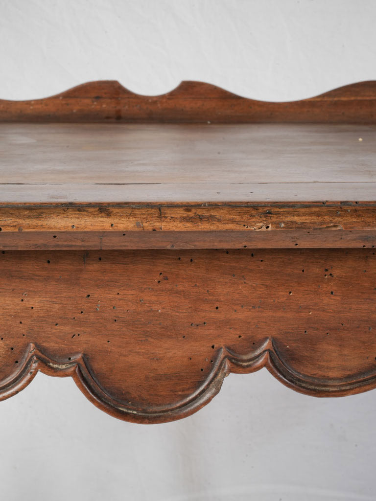 Poised serpentine apron table