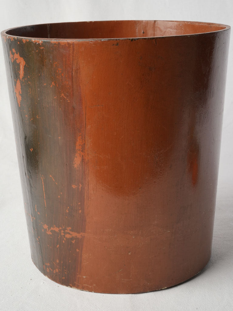 Timeworn cylindrical trash can  