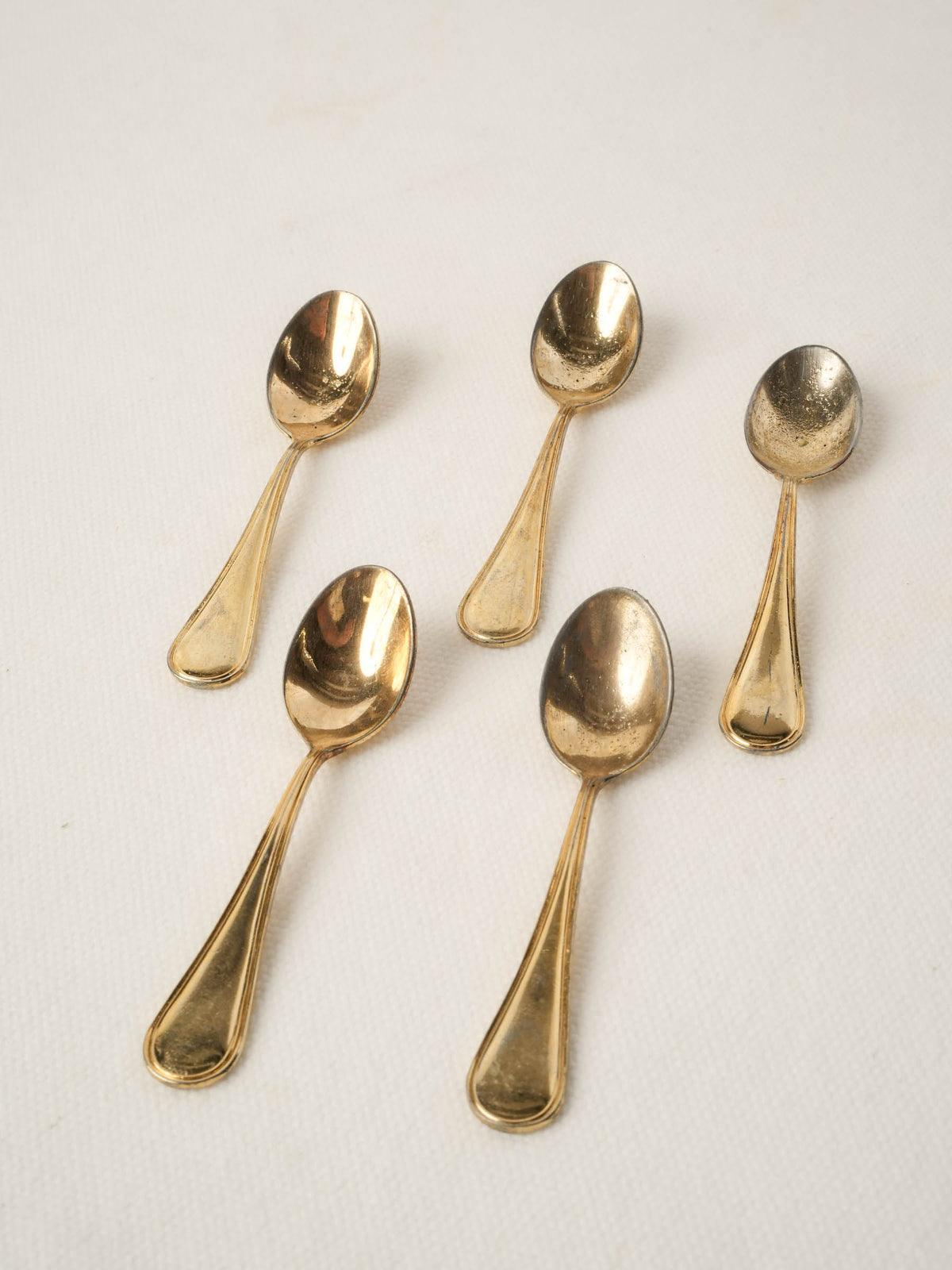 Set of five caviar spoons with gold patina