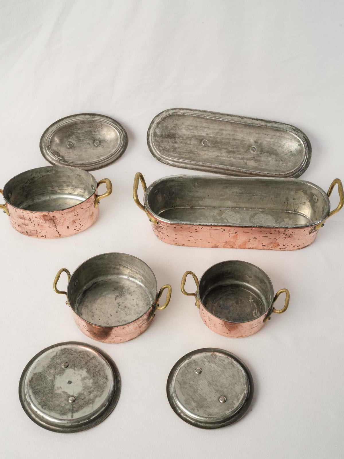 Set of four Copper Lidded Casseroles with Fish Kettle