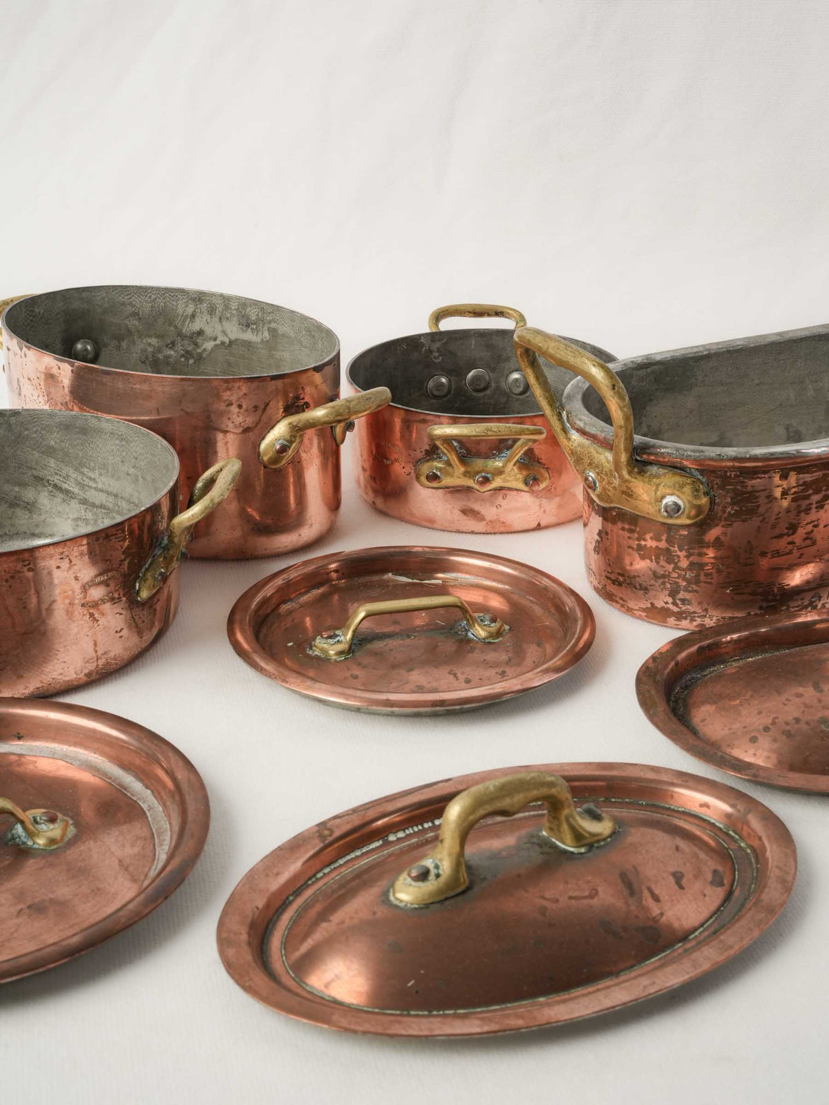 Set of four Copper Lidded Casseroles with Fish Kettle