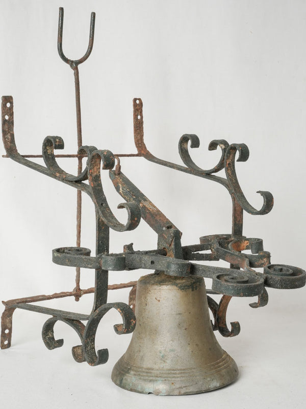 Antique bronze bell with wrought iron wall mount