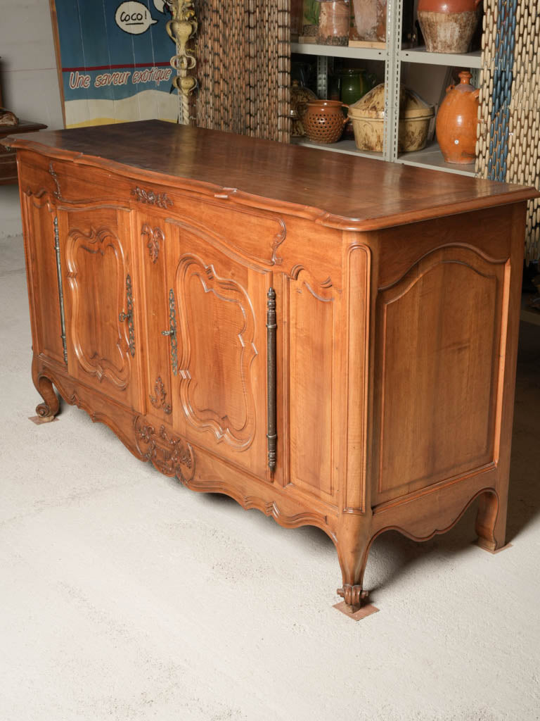 Serpentine façade walnut cabinets  