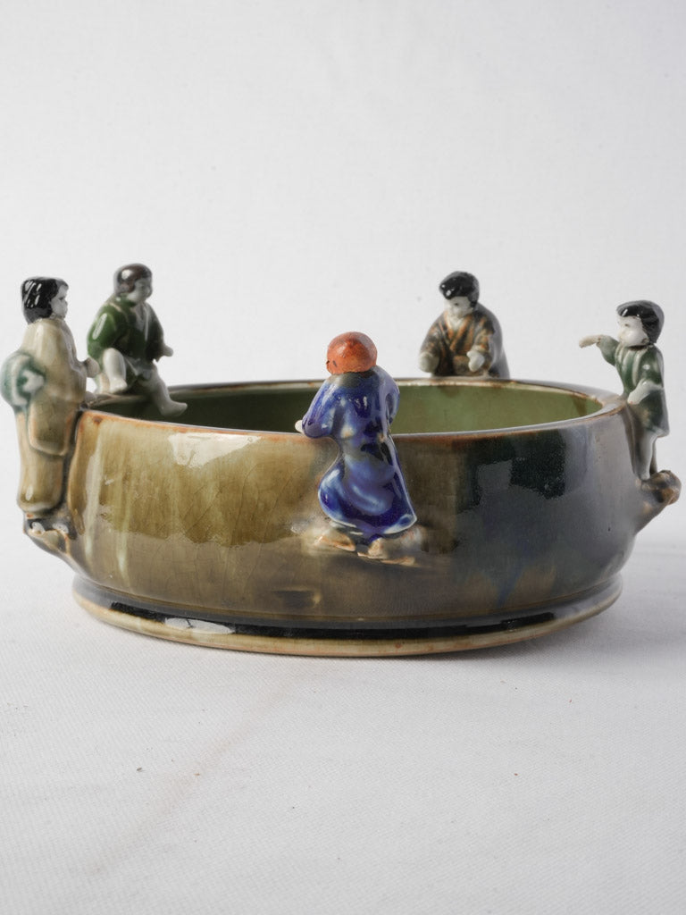 Whimsical figural relief pottery bowl  