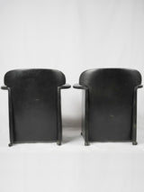 Functional wheeled black leather armchairs