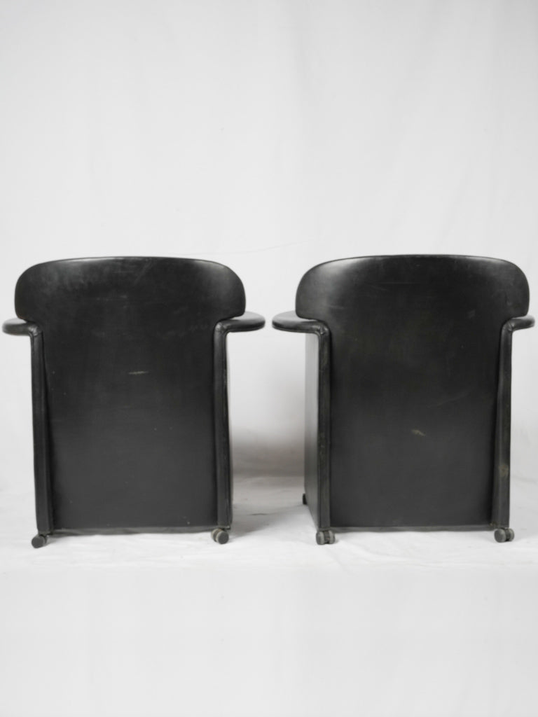 Functional wheeled black leather armchairs