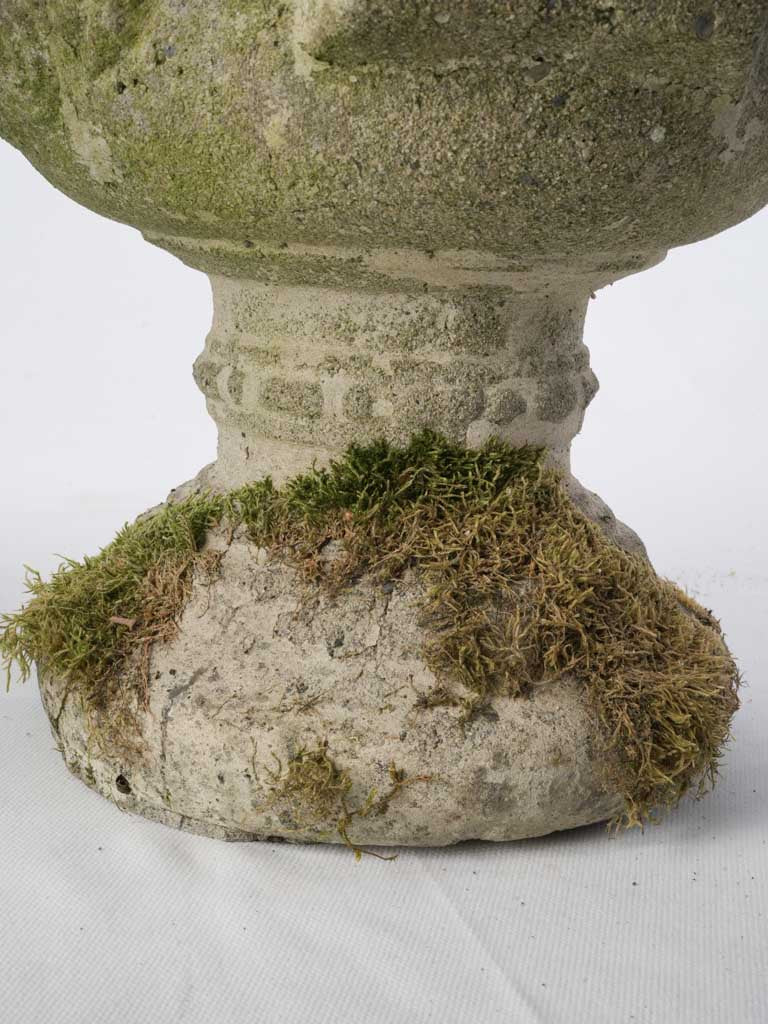 Stylized head-decorated urn